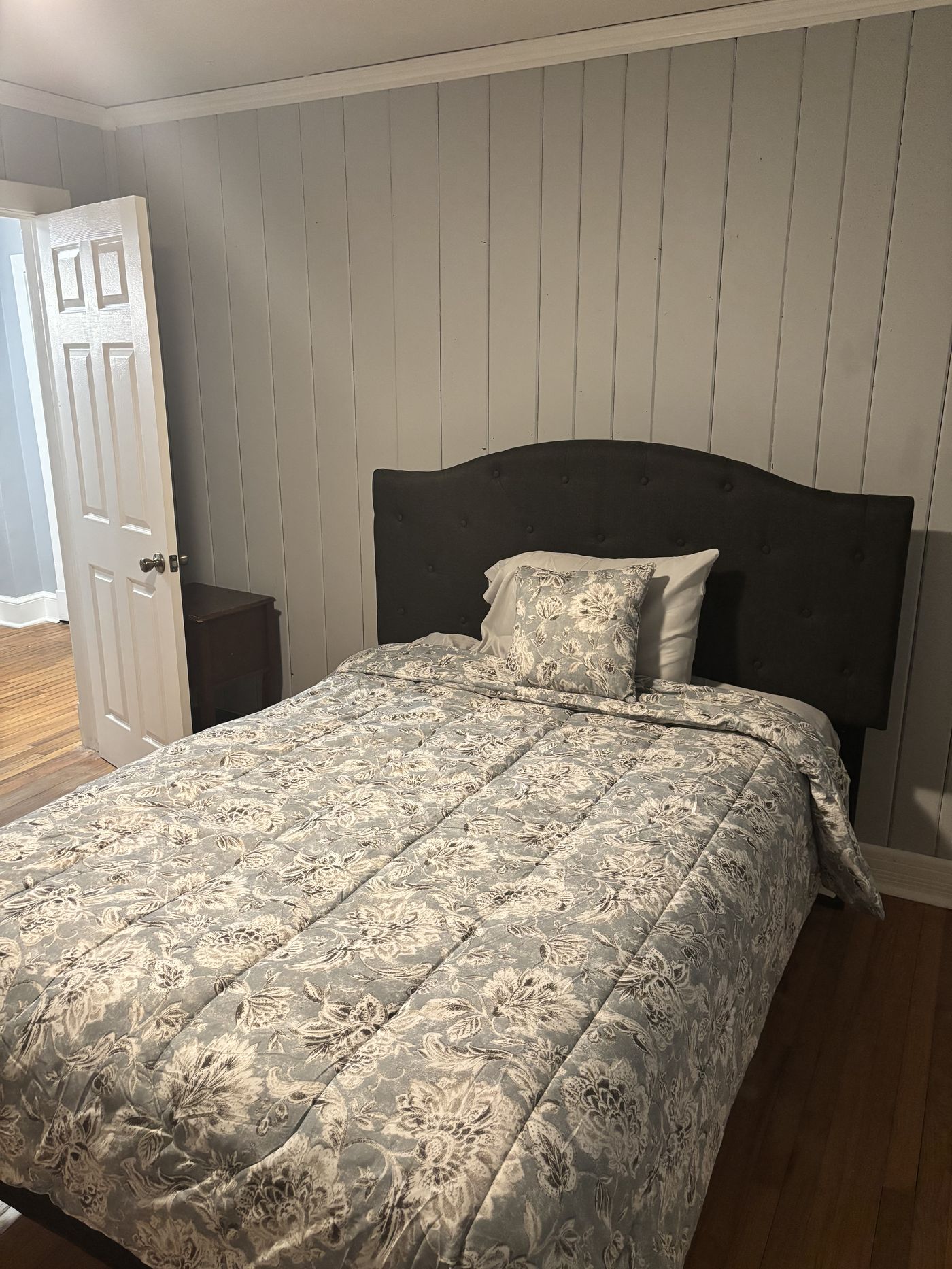 Bedroom with tufted headboard at House of Unity